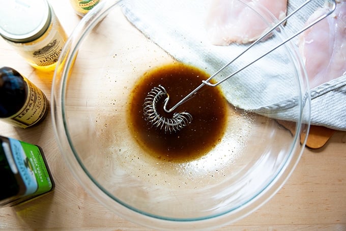 Marinade for grilled chicken whisked together in a large bowl.