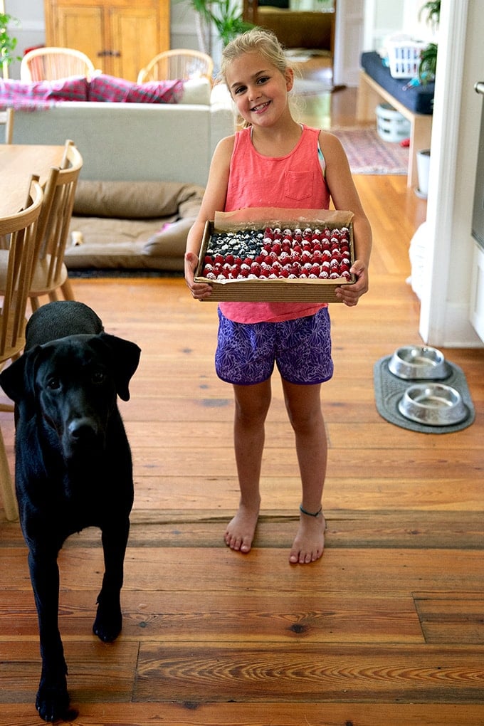 Wren, holding a flag cake, aside Pepe.