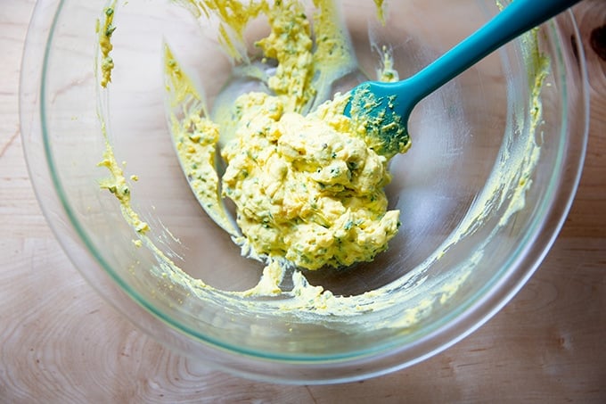 A bowl of mashed egg yolks, mayo, and chives, ready to be piped into the halved hard cooked egg whites.