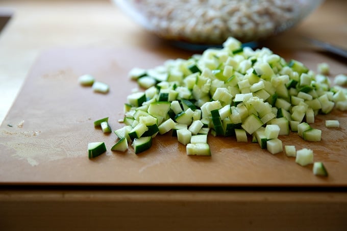 Diced zucchini on a cutting board.