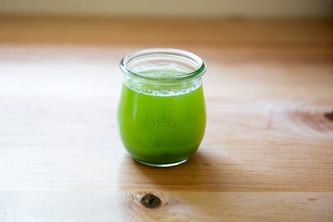 Drained zucchini liquid in a bowl.