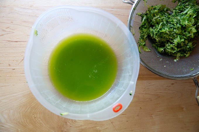 Zucchini liquid drained in a bowl.