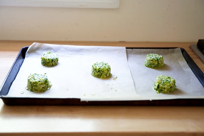 Zucchini tortilla batter mounds on a sheet pan.