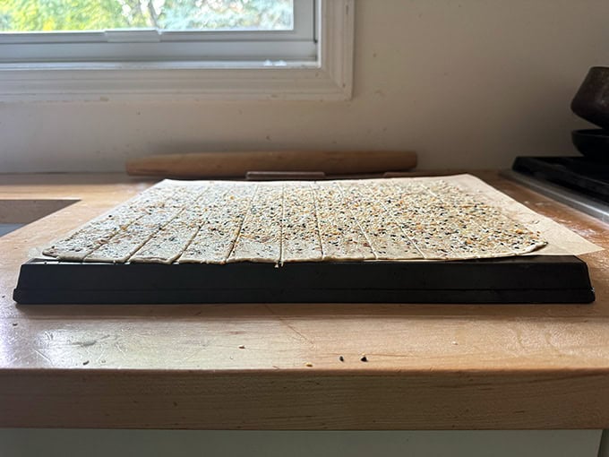 Unbaked sourdough discard crackers on an upside-down sheet pan.  - 123