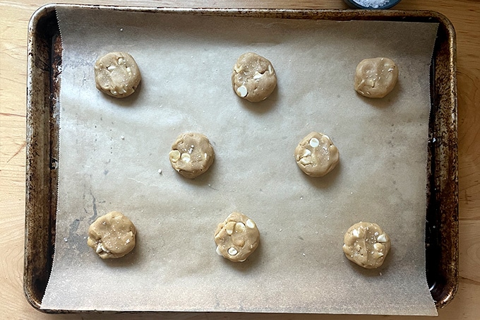 Portioned cookie dough balls on a sheet pan.