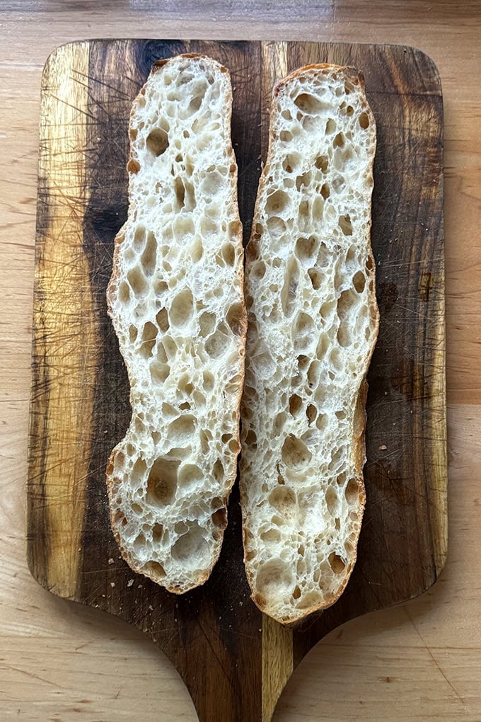 Halved open-crumb baguette. 