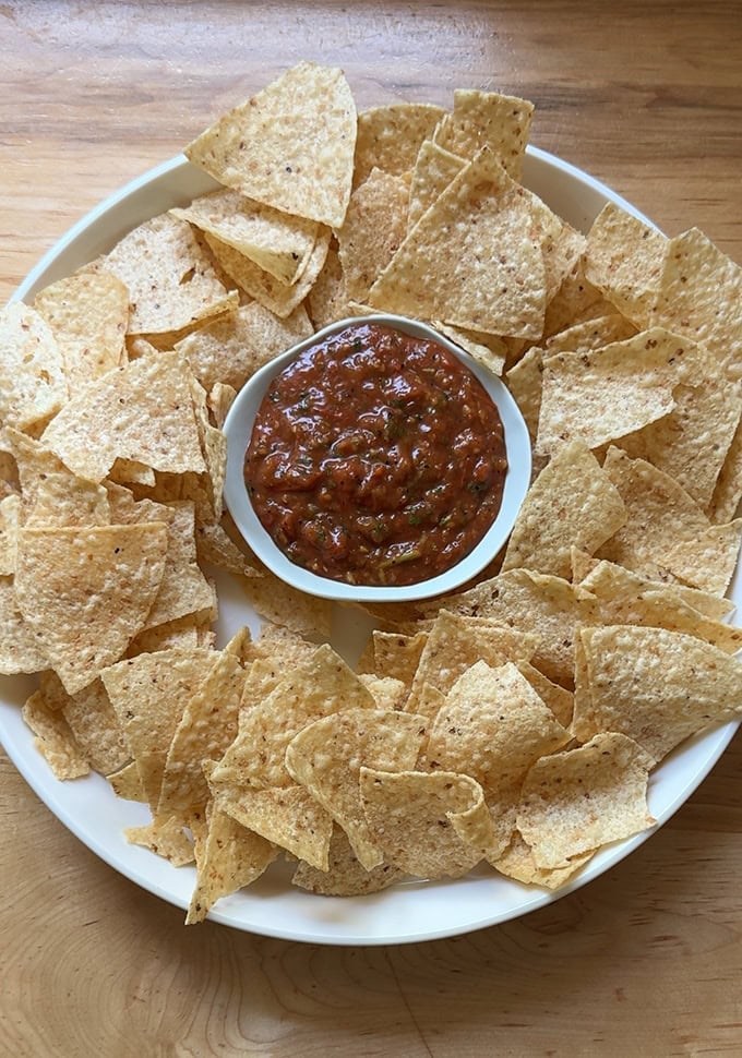 A bowl of chips with charred tomato salsa.  - 13