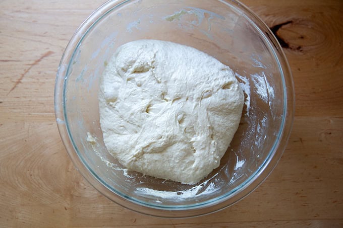 A bowl of sourdough discard toasting bread dough deflated after the first rise.