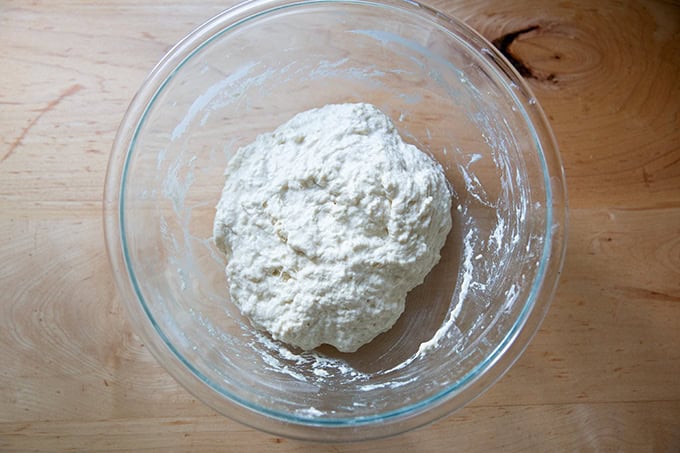 A large bowl holding just-mixed sourdough discard toasting bread dough.