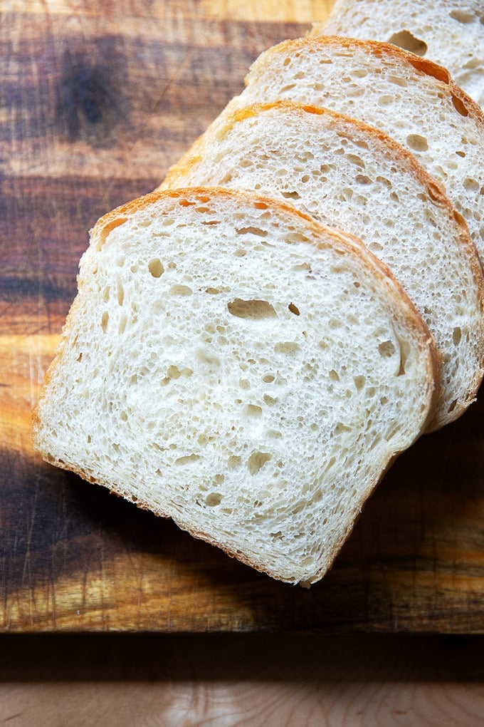 Sliced sourdough discard toasting bread on a cutting board.