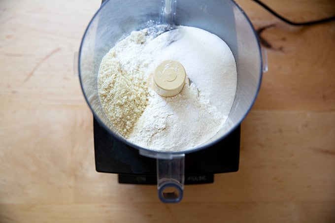 A food processor filled with the dry ingredients for a crisp topping.