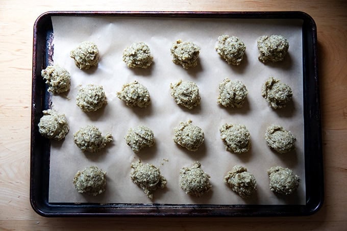 Portioned eggplant meatballs on a sheet pan, unbaked. - 10