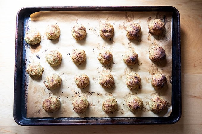 Roasted eggplant meatballs on a sheet pan. - 12