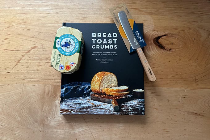 Bread Toast Crumbs cookbook with Opinel butter spreader and block of French butter.