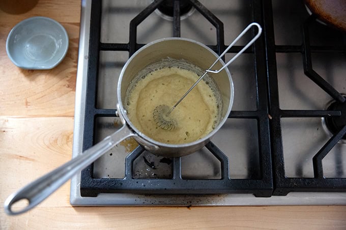 A small saucepan heating a small amount of butter and flour together for a roux. - 46