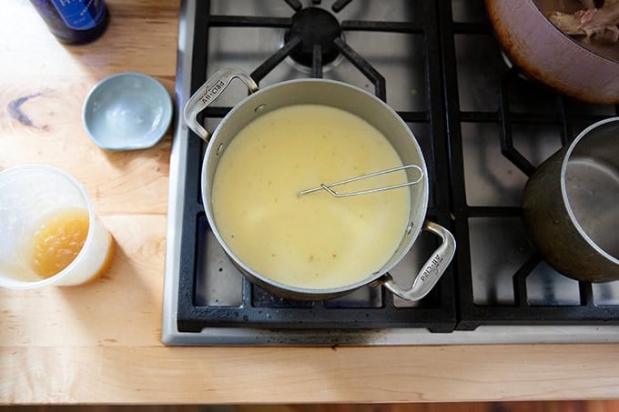 The gravy/bechamel sauce for Turkey Tetrazzini simmering on the stovetop. - 49