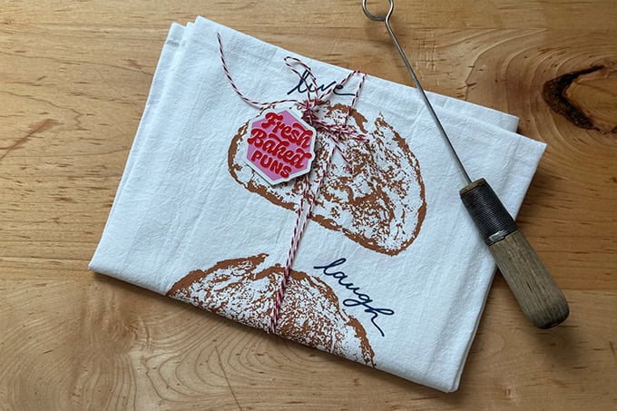 A Live Laugh Loaf printed tea towel.