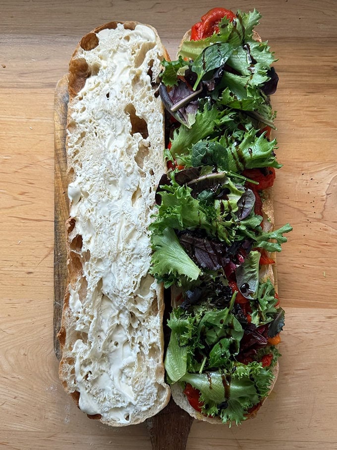 A giant sandwich made on a large roll.
