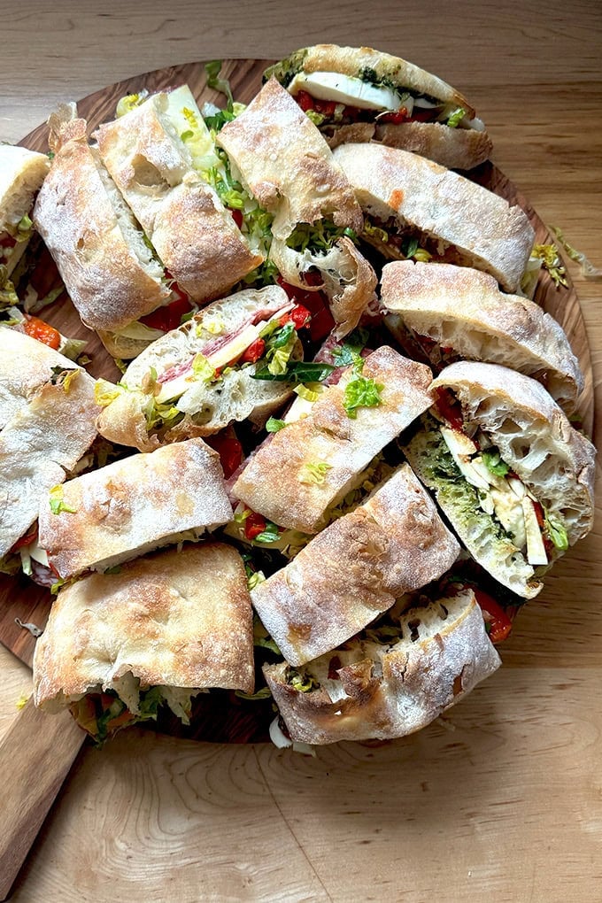 Sliced sandwiches on a board.