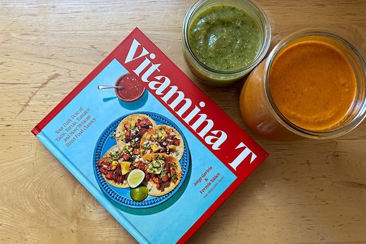 A book, Vitamina T, aside two Mexican sauces.
