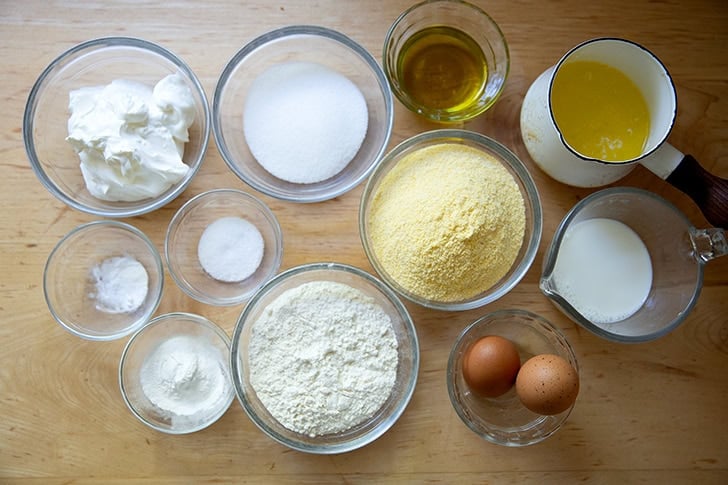 The ingredients to make cornbread all measured out on a countertop.