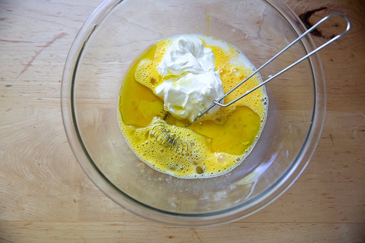 The wet ingredients to make cornbread in a large bowl.