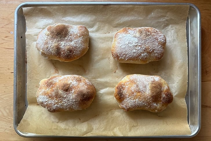 Just baked Overnight Sandwich Rolls on a sheet pan.