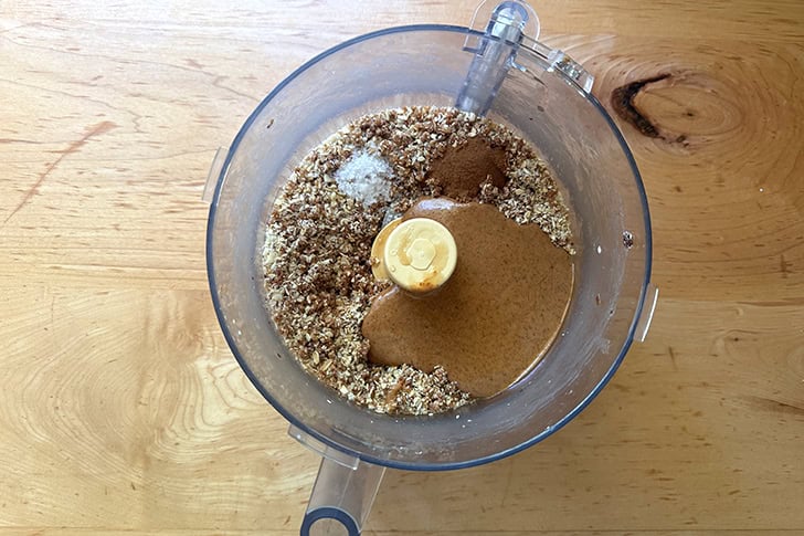 A food processor filled with the ingredients to make homemade energy bites.