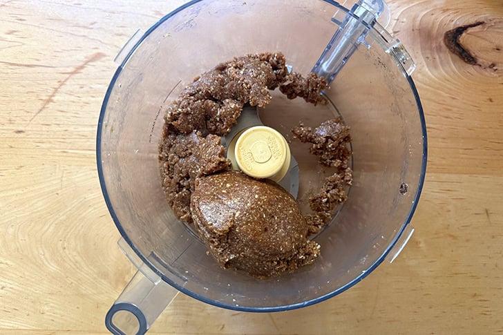 The energy bites "dough" in a food processor, ready to be portioned.