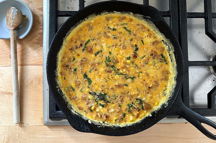 A frittata in a cast iron skillet ready for the oven.