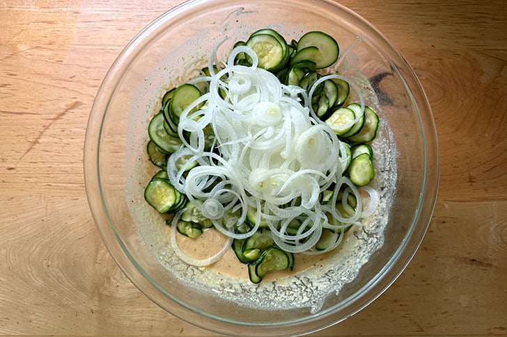 The salted and drained zucchini and onions added to the Scarpaccia batter.