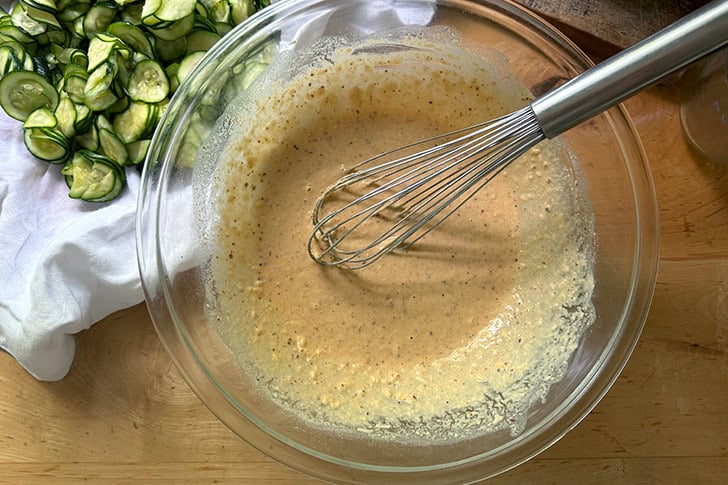 The batter for Scarpaccia whisked together in a large glass bowl.